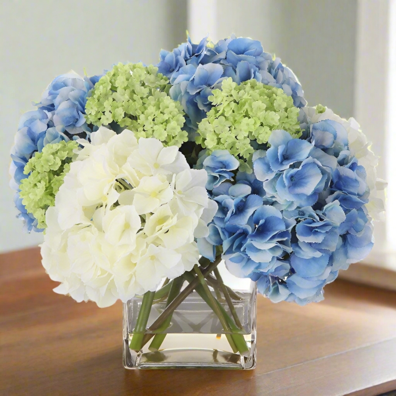 Multi Tonal Floral Arrangement in Square Glass Vase with Faux Water