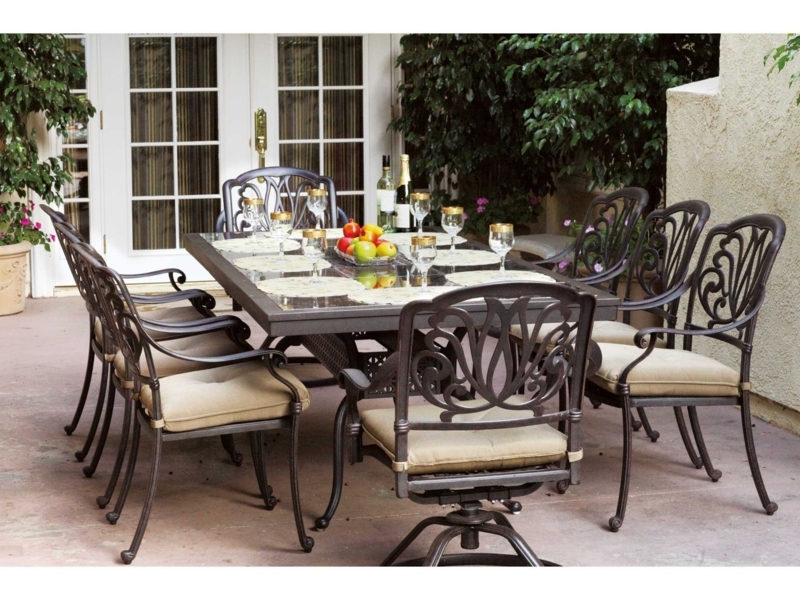 Outdoor Dining Set: Ornate Bronze, Granite Top, Swivel Armchair Feature.