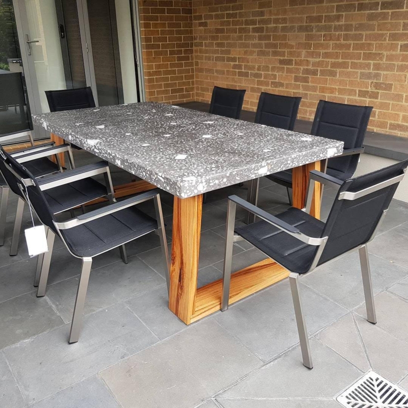 Outdoor Dining Table: Aggregate Stone Top, Hardwood Sled Base, Industrial.