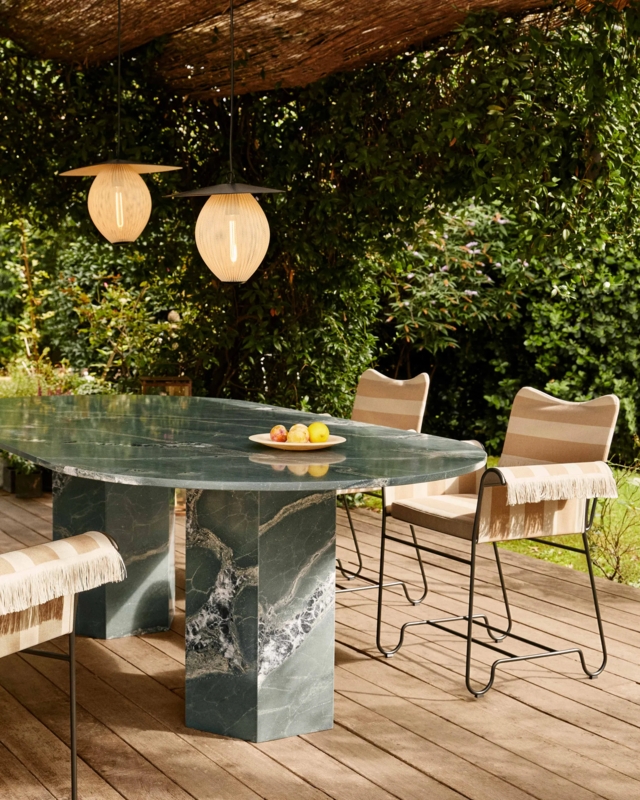 Outdoor Dining Table: Botanical Green Elliptical Stone Top, Hexagonal Base.