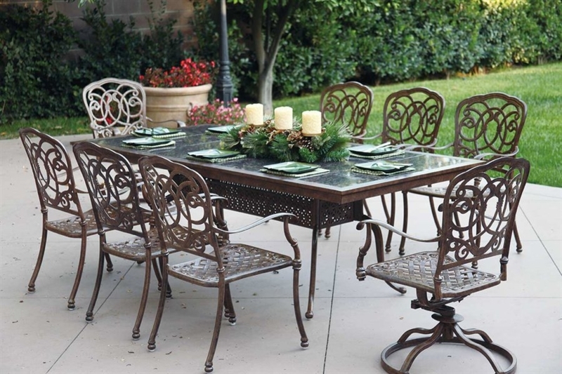 Patio Dining Set: Granite Tile Top, Swivel Base, Ornate Scrollwork Chairs.