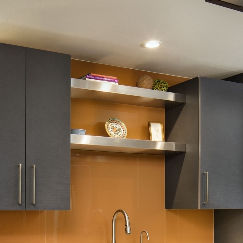 Stainless Steel Floating Shelves against Amber Backsplash