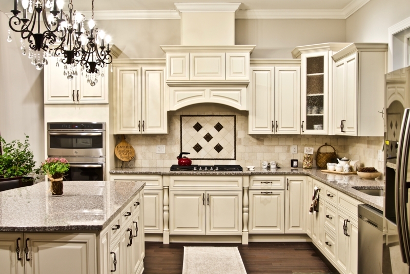 Traditional Ivory Cabinets with Crystal Chandelier and Granite