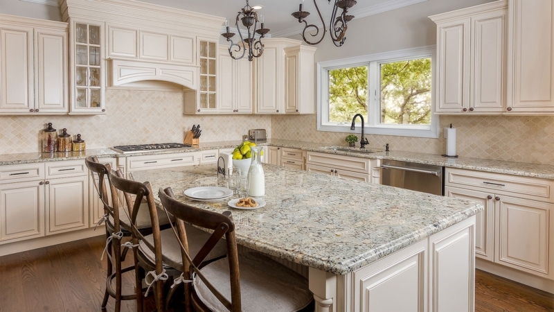 Traditional Ivory Raised Panel Cabinets with Speckled Stone