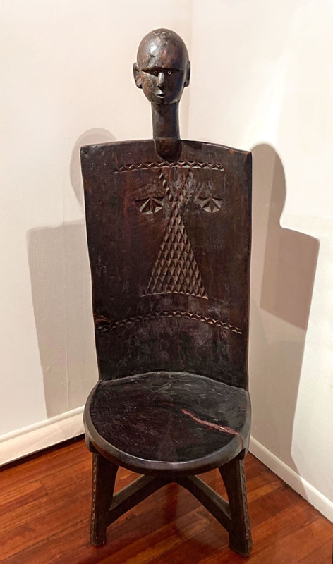 Tribal Accent Chair: Maconde Craftsmanship with Sculptural Head Finial