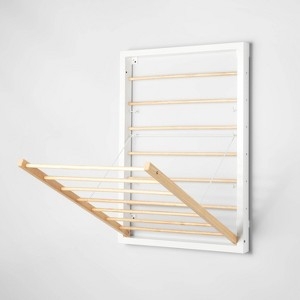 Wall Mounted Drying Rack: Folding Pull-Out White Frame, Wood Toned Rods.