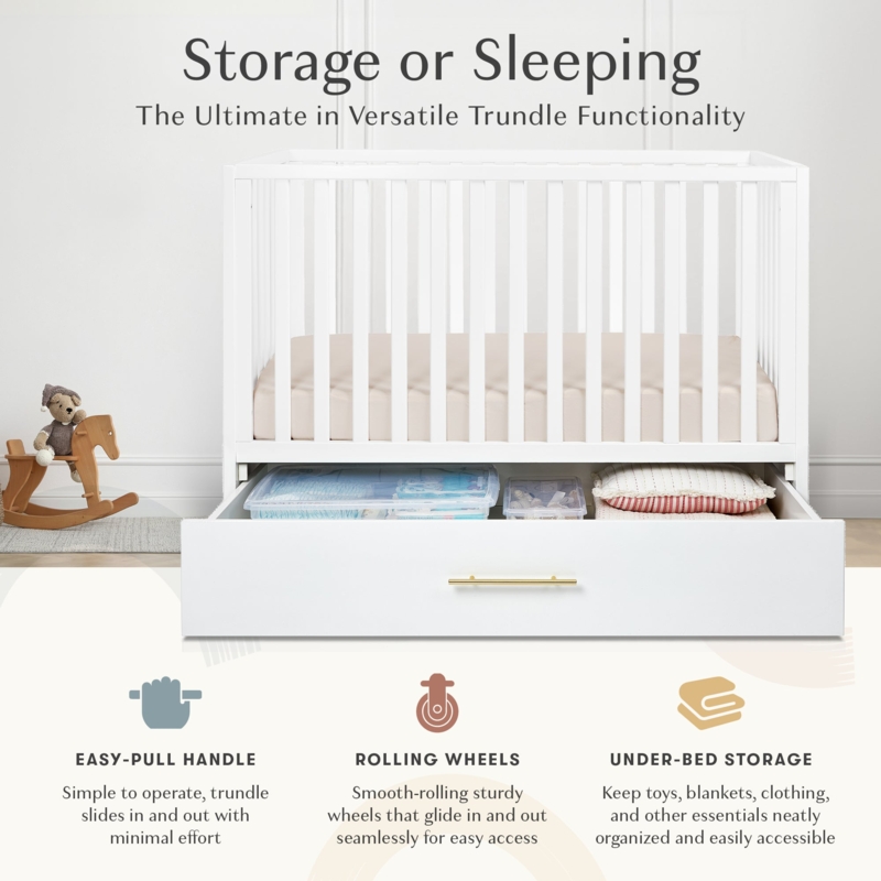 White Crib featuring Gold Hardware and Rolling Trundle Storage