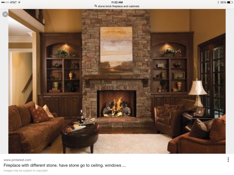 Arched Dark Wood Built-In Bookcases Flanking Stone Fireplace
