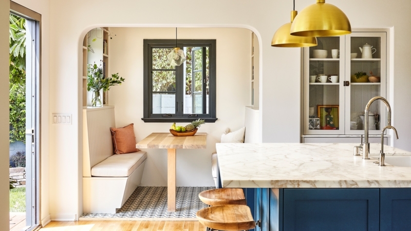 Breakfast Nook in Arched Entryway with Navy Island and Patterned Tile.
