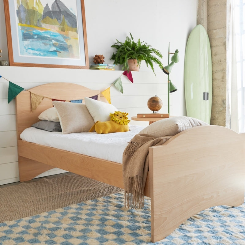 Coastal Modern Kids Trundle Bed with Curved Headboard and Natural Wood.