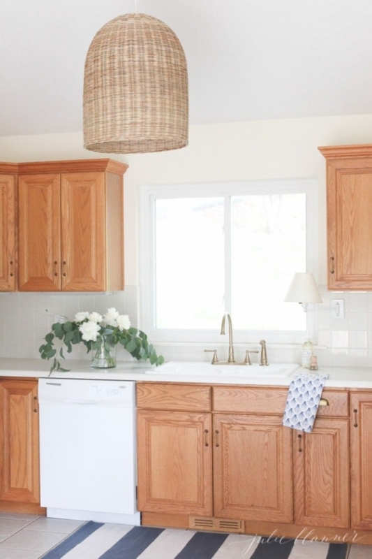 Coastal Style Cabinetry featuring Rattan Pendant Light