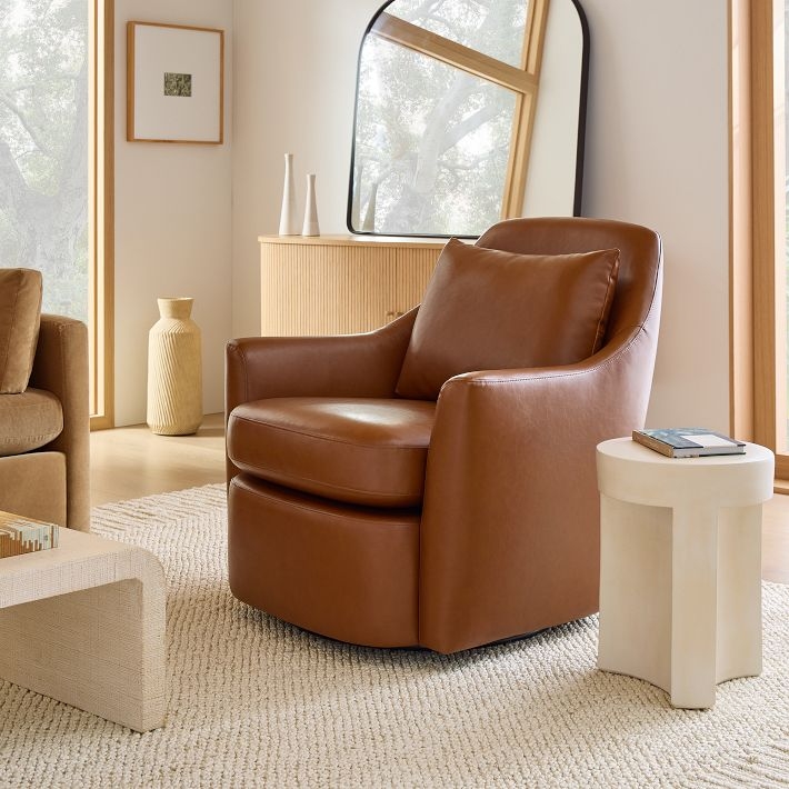 Curved Cognac Swivel Chair Sloping Arms Matching Pillow Organic Modern