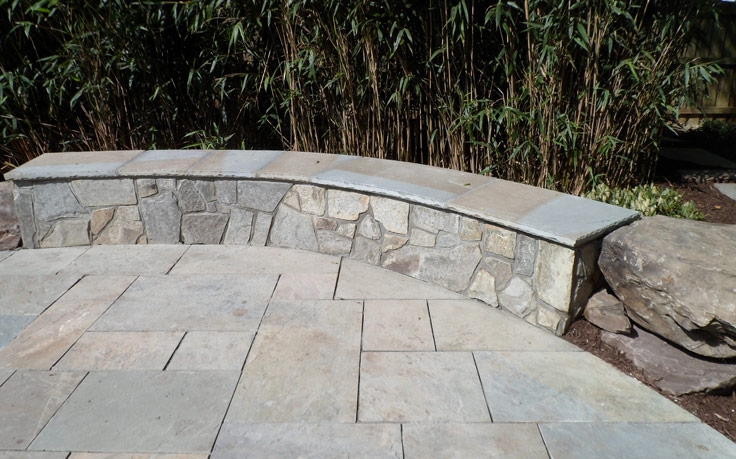 Curved Stone Bench with Variegated Flagstone Paving