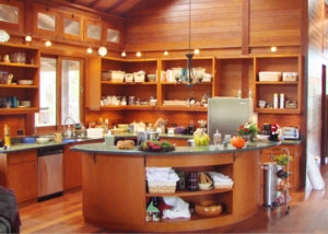 Curved Teak Kitchen Island with Honey Wood and Integrated Open Shelving