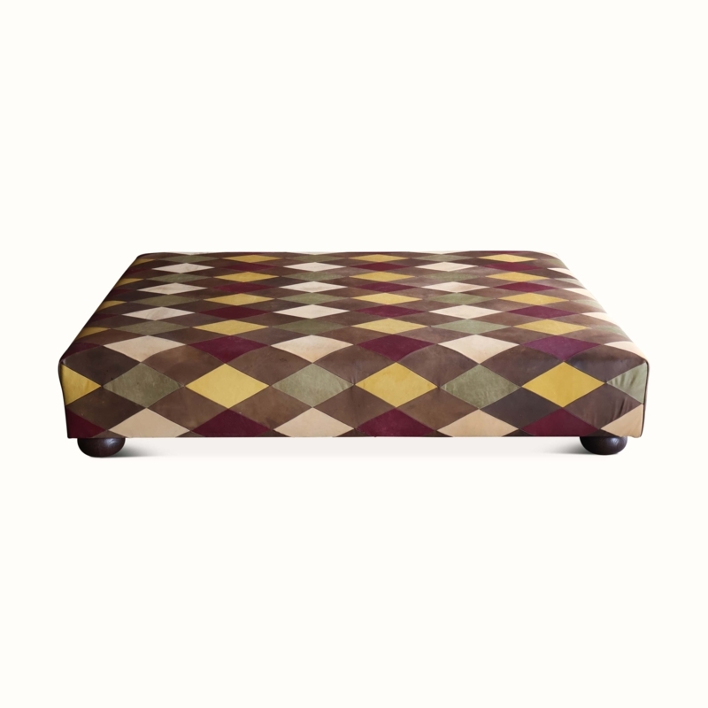 Diamond Patchwork Ottoman: Harlequin Pattern & Dark Bun Feet