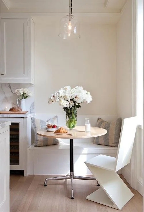 Dining Nook features Geometric Cantilever Chair and Glass Pendant.