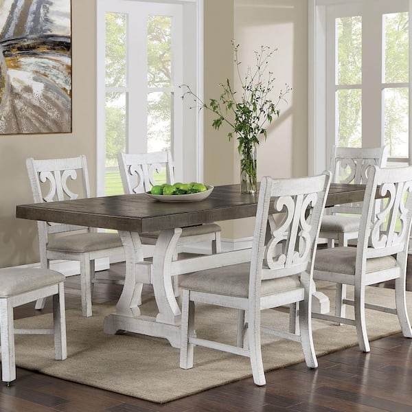 Dining Table: Weathered Gray Top, Trestle Base, Scroll Back Design.