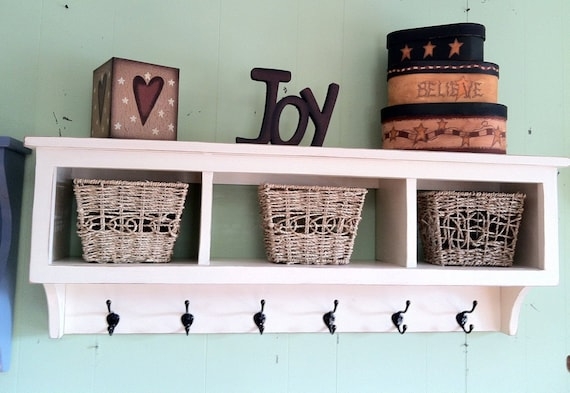 Distressed White Cubby Shelf with Six Black Hooks and Woven Baskets