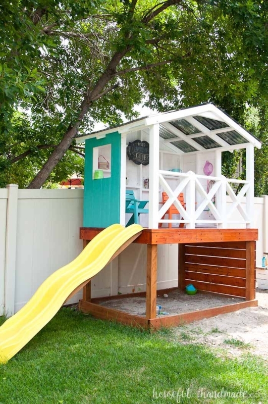 Elevated Playhouse with Slide, Sandbox Base & Teal Accent Wall