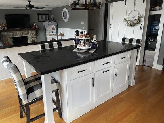 Farmhouse Kitchen Island With Black Quartz And Buffalo Check Stools