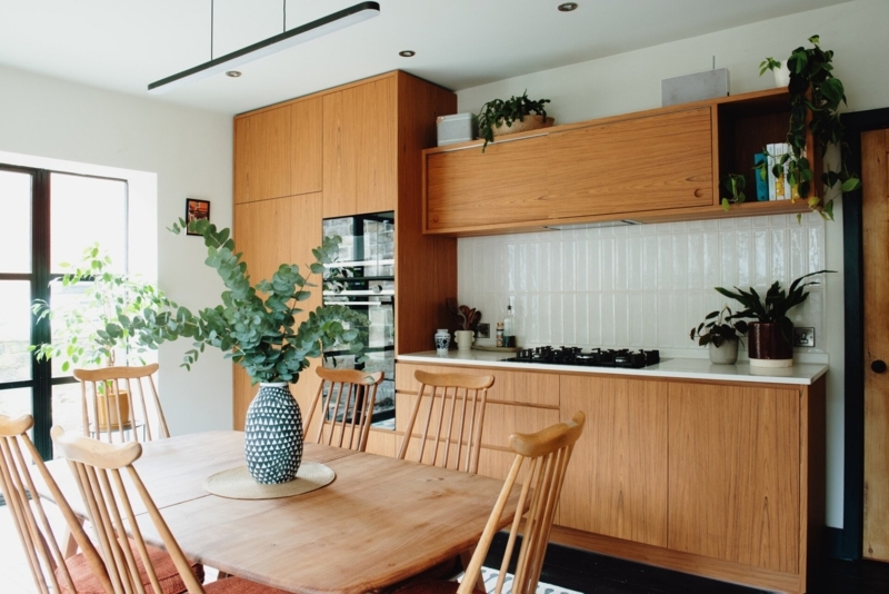 Fitted Kitchen with Sliding Upper Cabinets and Vertical White Tile