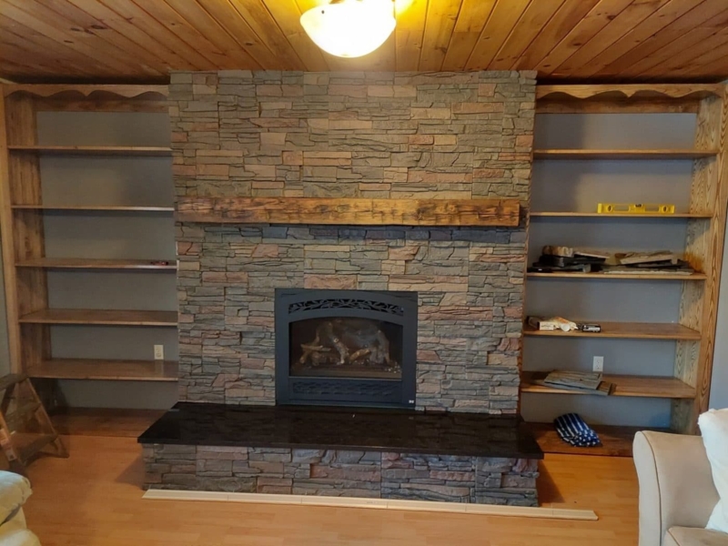 Floor to Ceiling Stone Fireplace with Flanking Wood Bookshelves