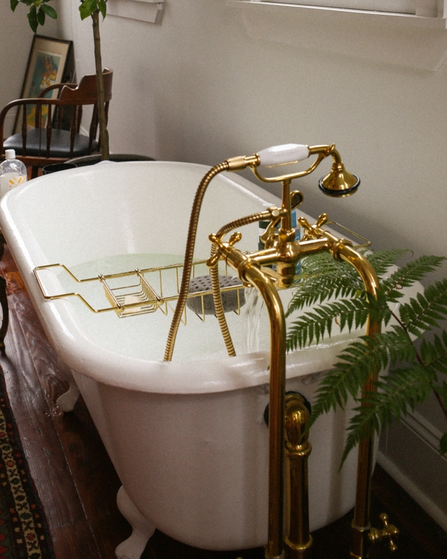 Glossy White Clawfoot Bathtub with Polished Brass Telephone Faucet & Hardware