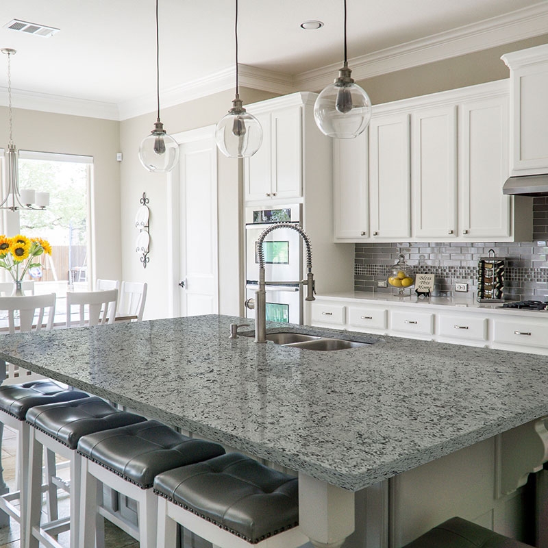 Granite Kitchen Island With Tufted Seating And Glass Globes