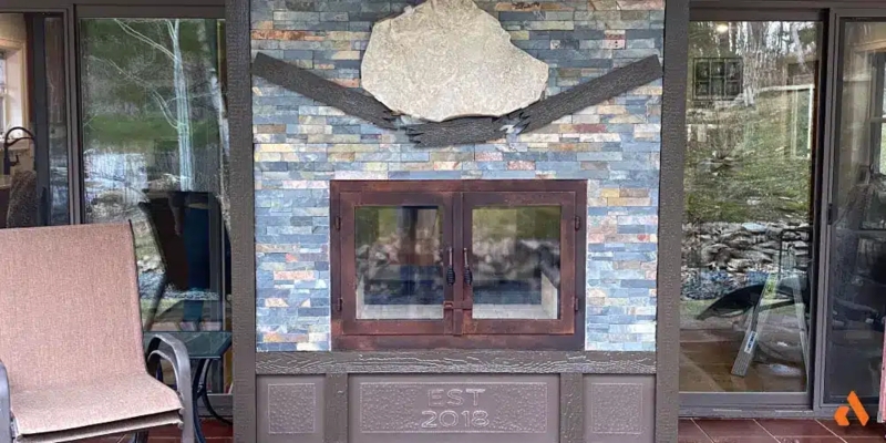Indoor Outdoor Fireplace with Custom Engraving and Stone Inlay