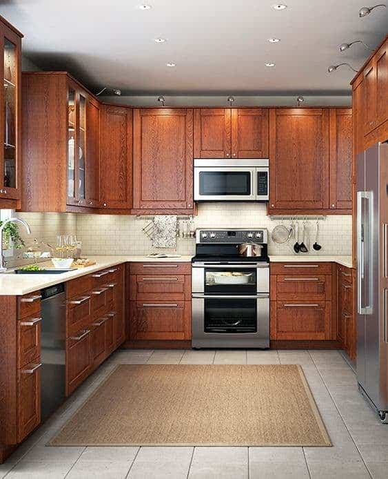 Kitchen Cabinetry with Glass Panes and Track Lighting in Transitional Style
