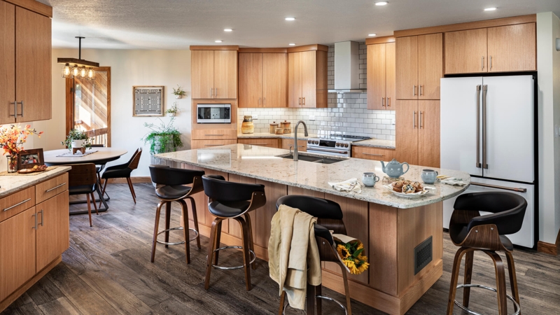 Kitchen Island featuring Curved Swivel Stools and Subway Tile