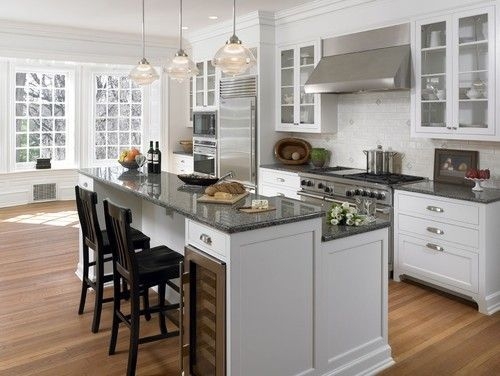 Kitchen Island Featuring Integrated Wine Cooler And Stone Top