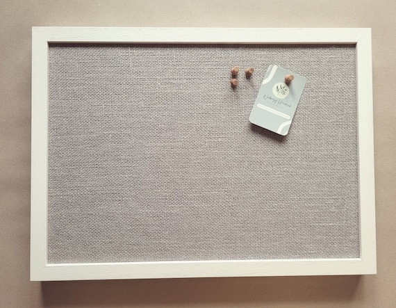 Light Grey Fabric Pinboard with Crisp Frame and Wooden Push Pins.