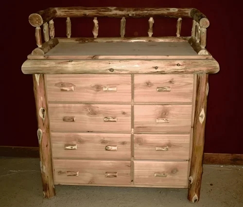 Lodge style baby dresser with bark accents and log railing