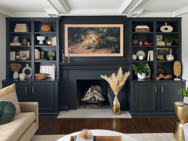 Matte Black Floor to Ceiling Built-In Bookcases with Integrated Fireplace