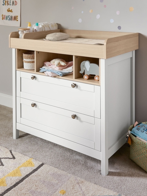 Modern white baby changer with oak accents and three cubbies