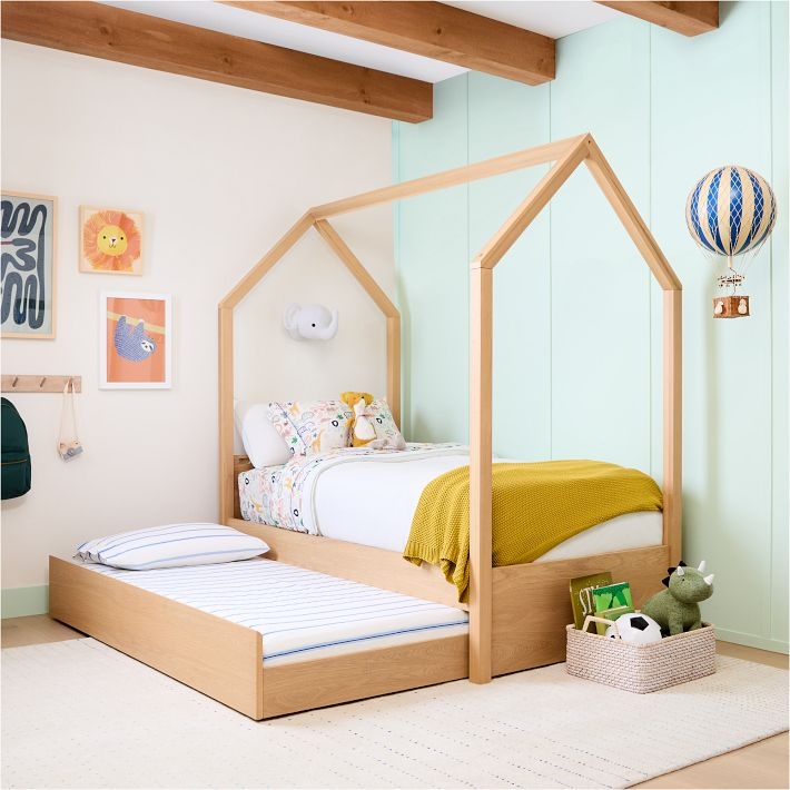 Natural Wood Trundle Bed with an Open Silhouette House Frame Design.