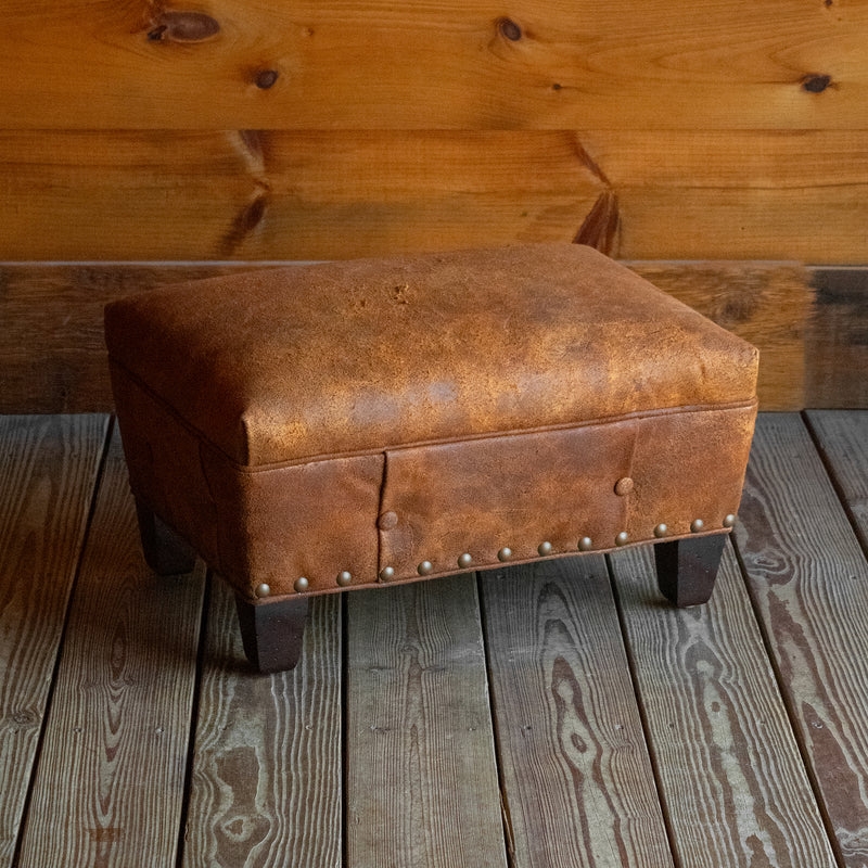 Ottoman with Distressed Leather Look and Nailhead Trim