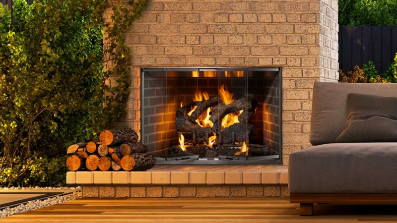 Outdoor Fireplace with Bifold Glass Doors and Tan Brick Surround