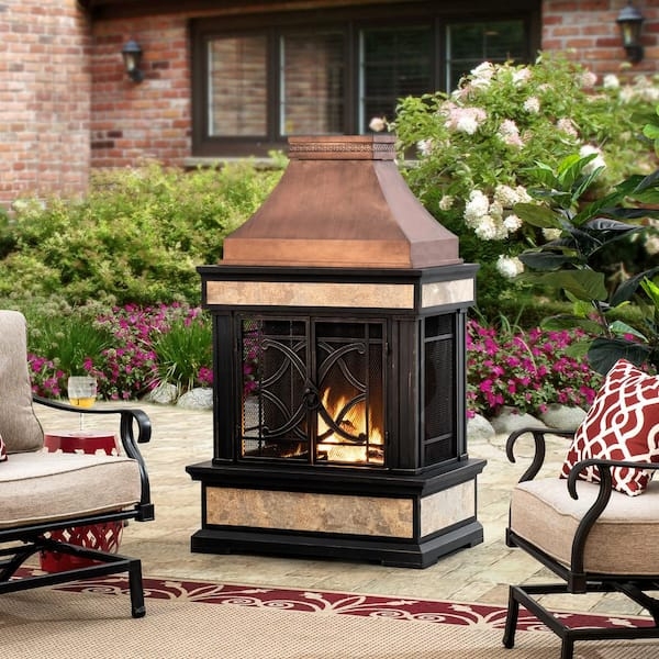 Outdoor Fireplace with Scrolled Door Pattern and Copper Hood