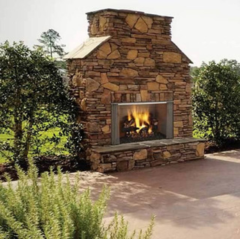Outdoor Fireplace with Stacked Stone and Raised Hearth Design