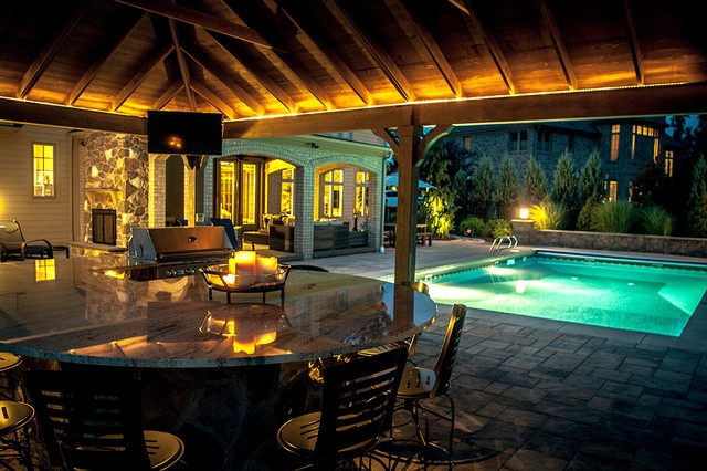 Outdoor Kitchen Pavilion: Curved Granite Island with LED Accents.