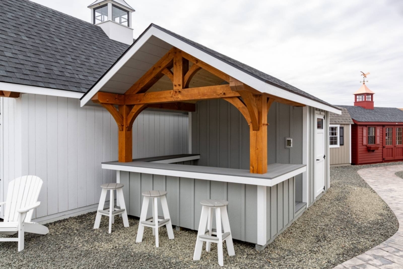 Poolside Bar: Light Gray Board and Batten Siding with Timber Truss.