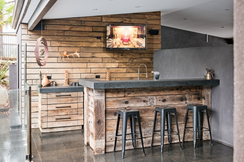 Reclaimed Wood Bar with Horizontal Planking and Industrial Stools