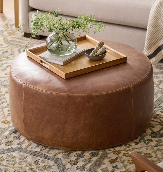 Round Ottoman: Large Scale, Cognac, Flat Top with Perimeter Stitching.