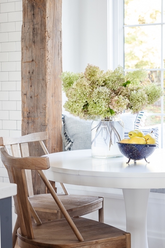 Round White Breakfast Table in Rustic Beam Dining Nook
