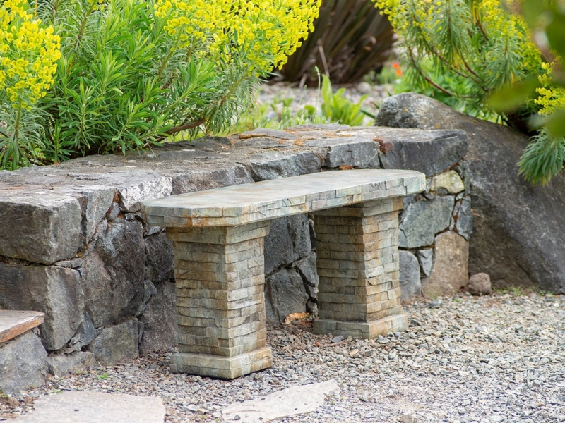 Stacked Stone Garden Bench: Weathered Slab Top & Pedestals.