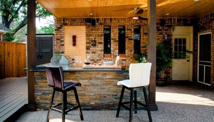 Stone Outdoor Bar with Wood Plank Ceiling and Integrated Grill