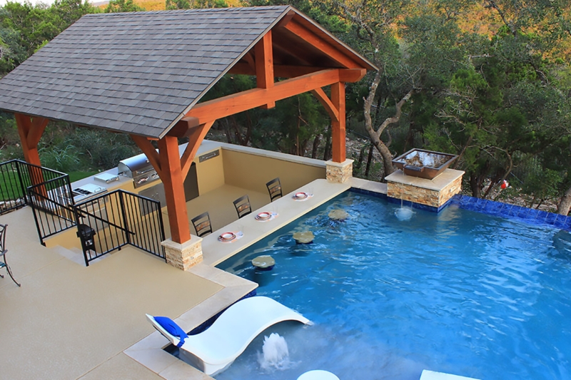 Swim Up Bar: Gabled Timber Structure with Submerged Stools and Grill.