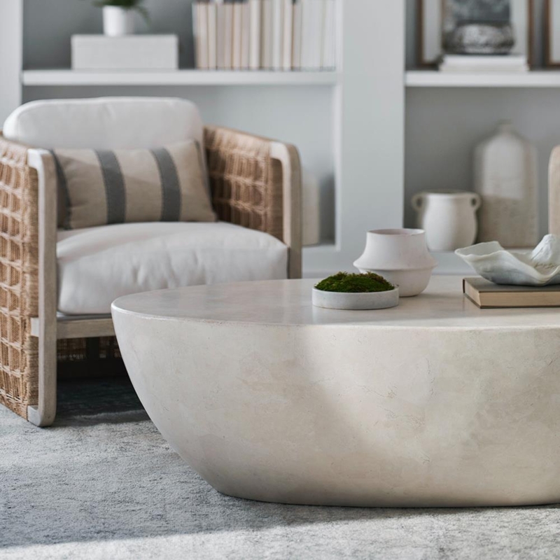 Textured Stone Oval Coffee Table, Woven Sides, Pedestal Base.